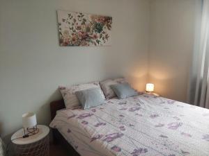 a bedroom with a bed and a painting on the wall at Apartment Fabris in Roč