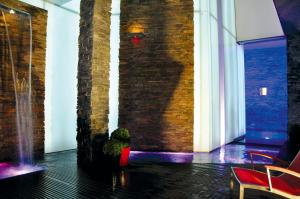 a room with a potted plant and a brick wall at Hotel Traube am See in Friedrichshafen