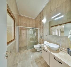a bathroom with two toilets and a sink and a shower at The Kaş Otel in Kaş +60 photos