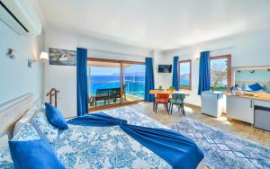 a bedroom with a bed and a view of the ocean at The Kaş Otel in Kaş