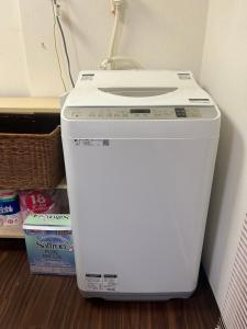 a washer and dryer sitting on the floor in a room at Shalom House Yokosuka in Yokosuka