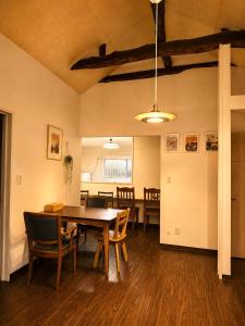 a dining room with a table and chairs at Shalom House Yokosuka in Yokosuka