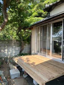 a wooden deck in front of a house at Shalom House Yokosuka in Yokosuka
