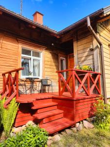 a wooden deck on the side of a house at Viesu Nams Vilhelmīne in Līgatne