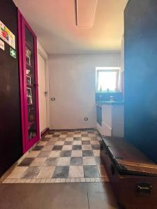 a room with a checkered floor and a red door at Solaris Guest House in Ciampino