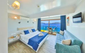 a hotel room with a bed and a couch at The Kaş Otel in Kaş
