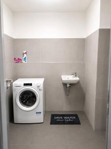 a washing machine and a sink in a bathroom at Harmony Metropolis Bratislava Free Parking in Nivy