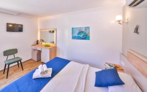 a small bedroom with a bed and a desk at The Kaş Otel in Kaş