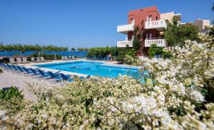 a resort with a swimming pool and a building at Ekavi Apartments in Agia Marina Nea Kydonias