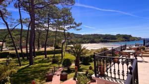 a balcony of a house with a view of the water at Hotel Restaurante Playa de Estorde in Cee