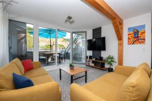 a living room with two couches and a table at Ferienwohnung Cella in Zell an der Mosel