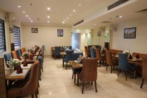 a dining room with tables and chairs in a restaurant at Hotel West End View A Unit of Hotel SC Residency in Zirakpur