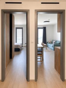 a bedroom and a living room with a bed and a table at Harmony Metropolis Bratislava Free Parking in Nivy