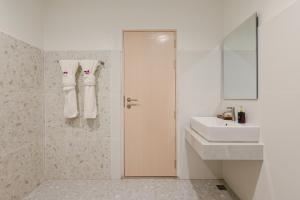 a white bathroom with a sink and a mirror at Little Home Ao Nang in Ao Nang Beach +69 photos
