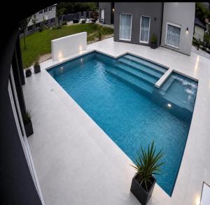 a swimming pool in the middle of a yard at Villa Nature in Sarajevo