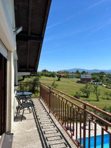 a balcony with a table and a view of a field at Breze Away in Tuzla
