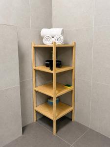 a wooden shelf in a bathroom with a towel at Harmony Metropolis Bratislava Free Parking in Nivy +14 photos