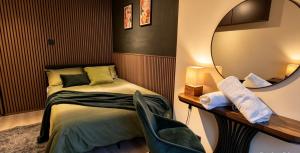 a bedroom with a bed with a mirror and a chair at The Hideout Middlesbrough Great Location in Middlesbrough