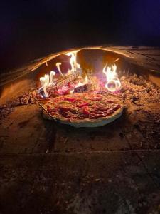 a pizza is being cooked in an oven at Vintage cabin - Sauna, grill, rural, close to lake & snowmobile trails, skiing in Boden