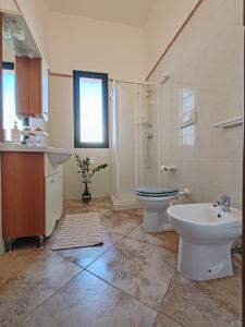 a bathroom with a sink and a toilet and a sink at Masseria Don Egidio in Melendugno