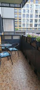 a balcony with a table and chairs and flowers at Vita apartment in Vilnius +4 photos