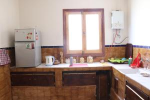 a kitchen with a refrigerator and a window at Welcomehome in Chefchaouen +29 photos