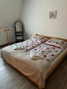 a bed in a bedroom with a cross on the wall at PENZION VLASTA in Zlín +11 photos