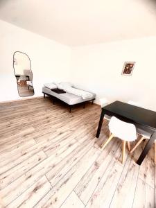 a room with a bed and a desk and a chair at La Résidence Urbaine in Mulhouse