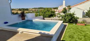 a swimming pool in the backyard of a house at Casinha do Cercal in Cercal