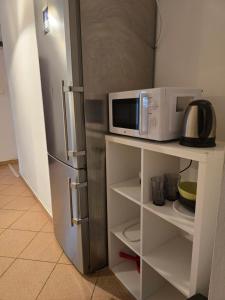 a kitchen with a microwave and a refrigerator at Home 24 check-in in Poznań