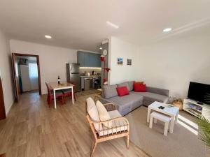 a living room with a couch and a table at Casinha do Cercal in Cercal