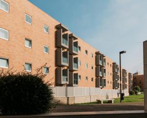 a brick building with balconies on the side of it at La Guardia Apartment in Póvoa de Varzim