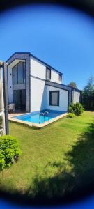 a house with a swimming pool in a yard at Villa Eliz in Dalaman