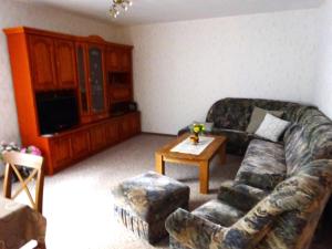 a living room with a couch and a coffee table at Ferienwohnung Pfanne in Großkoschen