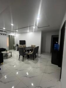 a living room with a table and chairs at Private Bedroom with a private bathroom in Bolorunpelu