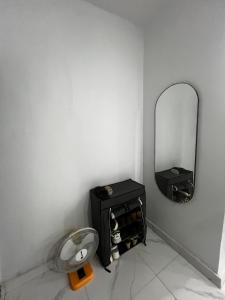 a corner of a room with a mirror and a table at Private Bedroom with a private bathroom in Bolorunpelu
