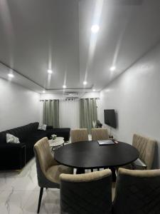 a living room with a table and chairs at Private Bedroom with a private bathroom in Bolorunpelu
