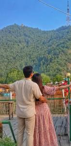 a man and a woman looking at a mountain at Budget Cottage By Aristotle in Srinagar