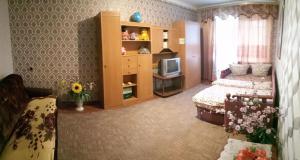 a bedroom with a bed and a tv in it at Квартира in Konotop