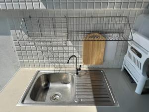 a kitchen sink with a faucet in a kitchen at MUJI House Poolvilla Pattaya in Na Jomtien +34 photos