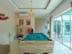 a pool table in a living room with at MUJI House Poolvilla Pattaya in Na Jomtien