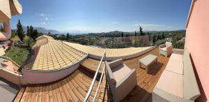 a roof of a building with a view of a valley at Penelope Apartment Hotel in Dassia