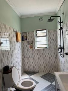 a bathroom with a toilet and a sink at Villa maasai in Kimana +35 photos