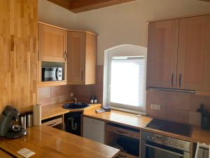 a kitchen with wooden cabinets and a wooden counter top at Ferienhaus Kobel in Stromberg