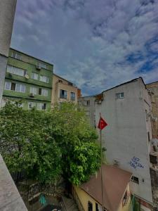 a group of buildings and a tree in front of a building at Green Suite in Istanbul