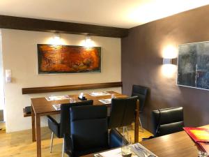 a restaurant with tables and chairs and a painting on the wall at Rustico senza punti in Contra