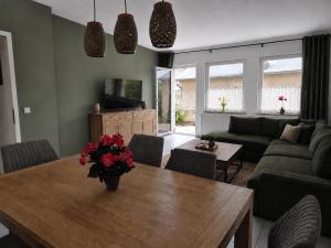 a living room with a wooden table with flowers on it at Zum alten Hafen Wesenberg in Wesenberg