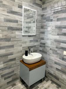 a bathroom with a sink and a mirror at Mamuka's Guesthouse in Udabno +64 photos