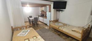 a small room with two beds and a kitchen at Apartmani Vučević in Sutomore