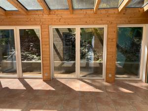 a group of glass doors in a building at Ferienhaus Kobel in Stromberg